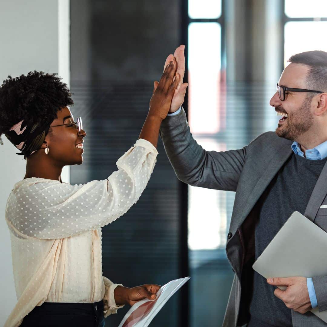 Leadership coach high-fiving her coaching client